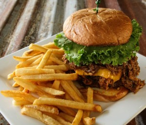 Cheeseburger with lettuce and fries on a white plate